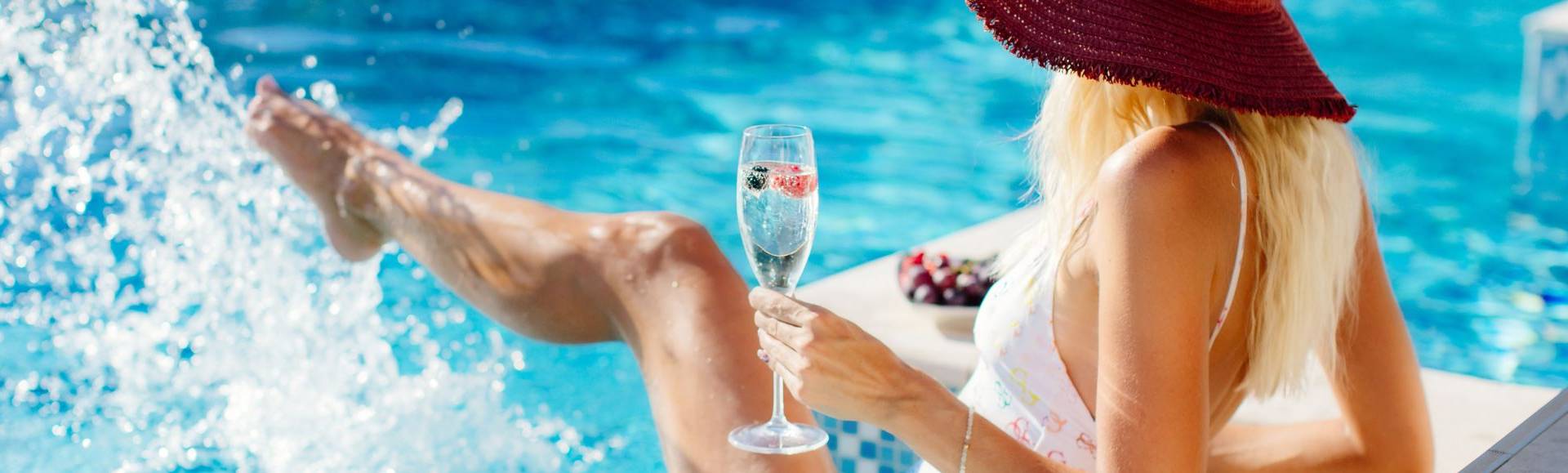 Woman with drink in pool