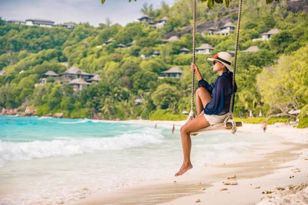 seychelles beach green vegetation swing with vacationers